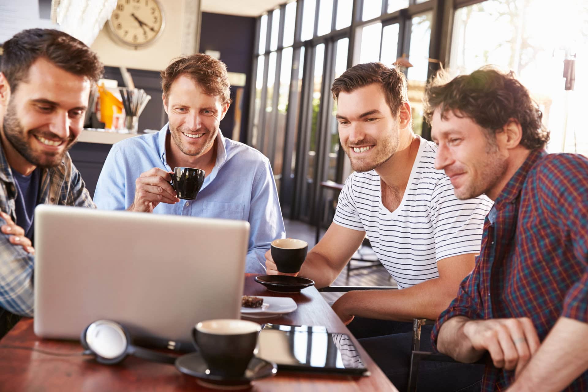 Group,Of,Men,Looking,At,A,Laptop,Together,At,A